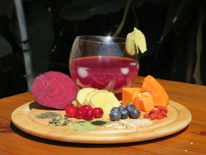 A refreshing glass of Athlete's Mix Water Kefir with a display of all the ingredients.