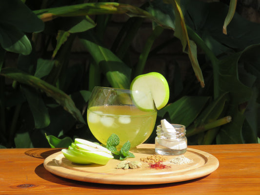 A refreshing glass of Zest Replenisher Water Kefir with a display of all the ingredients.